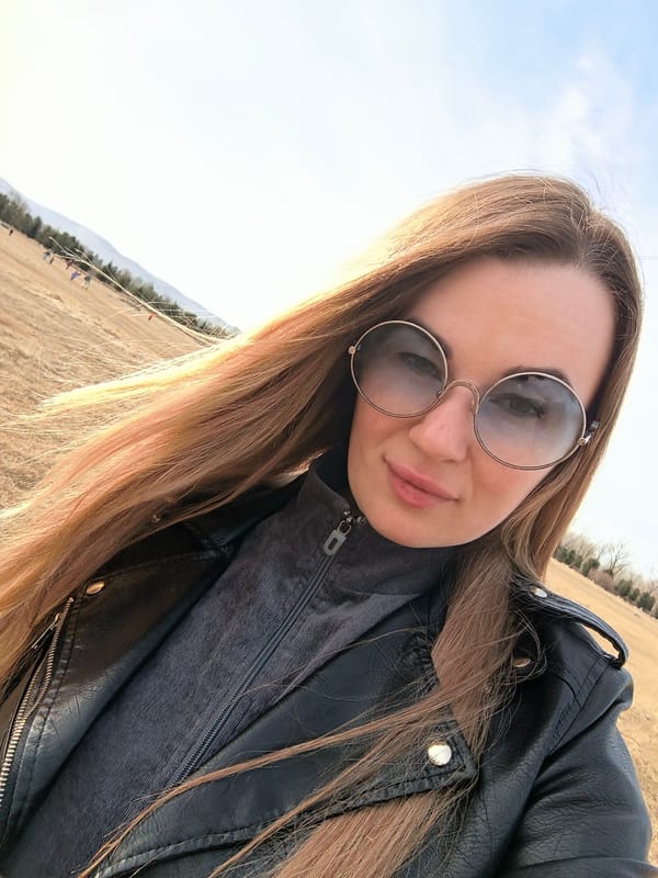 Woman takes selfie with dressed-up dog in Krasnoyarsk field