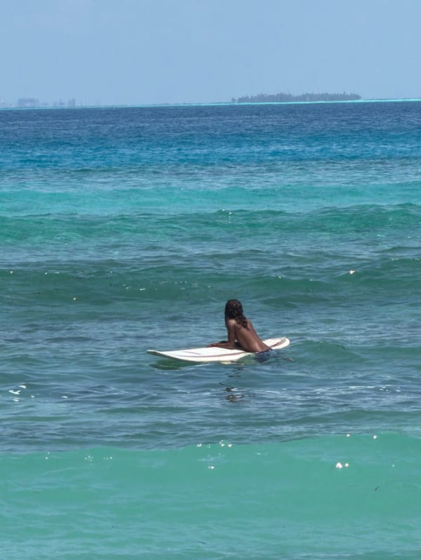 Morning surf session and beach activities in Maafushi, Maldives