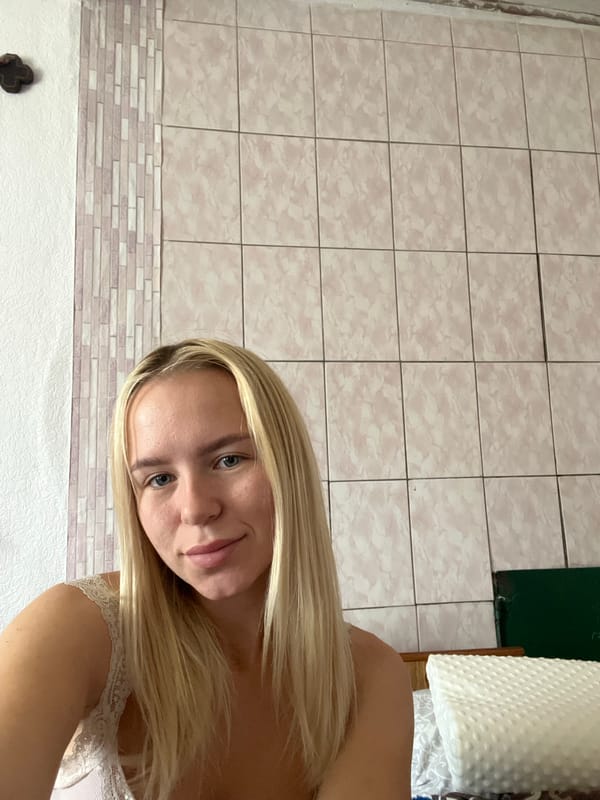 Indoor selfie session surrounded by patterned walls and couple paintings