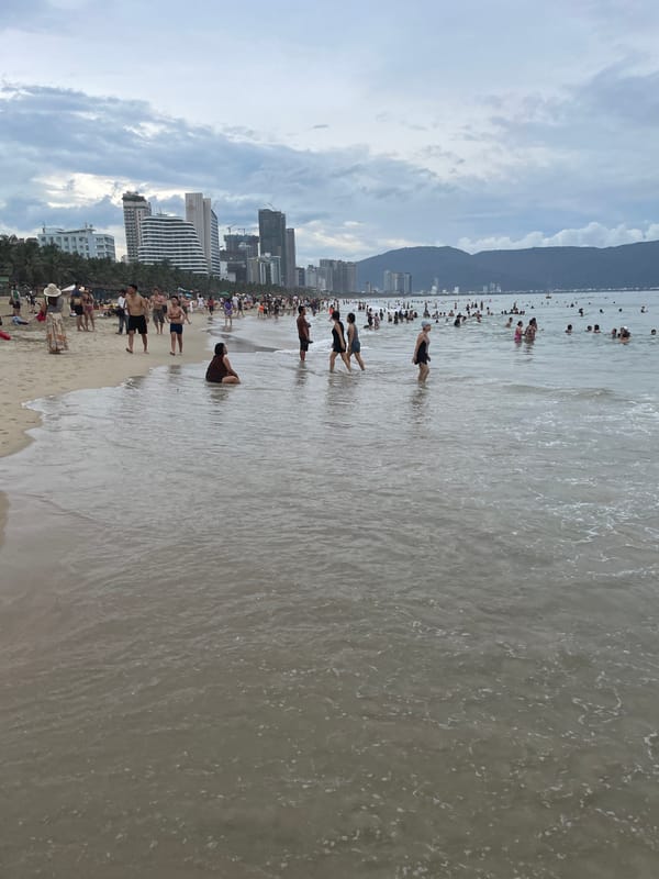 Crowded day at My Khe Beach, Đà Nẵng, under grey skies