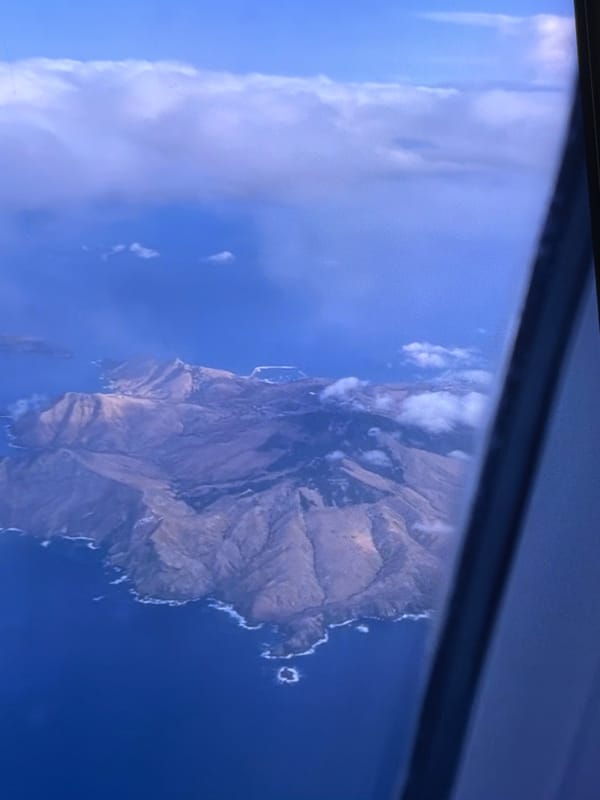 Flight over volcanic islands, tarmac stops at a sunny island airport