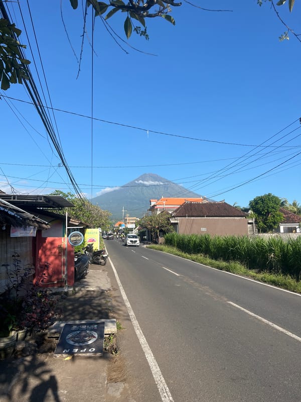 Street scene captured with volcano backdrop in Abang, Indonesia