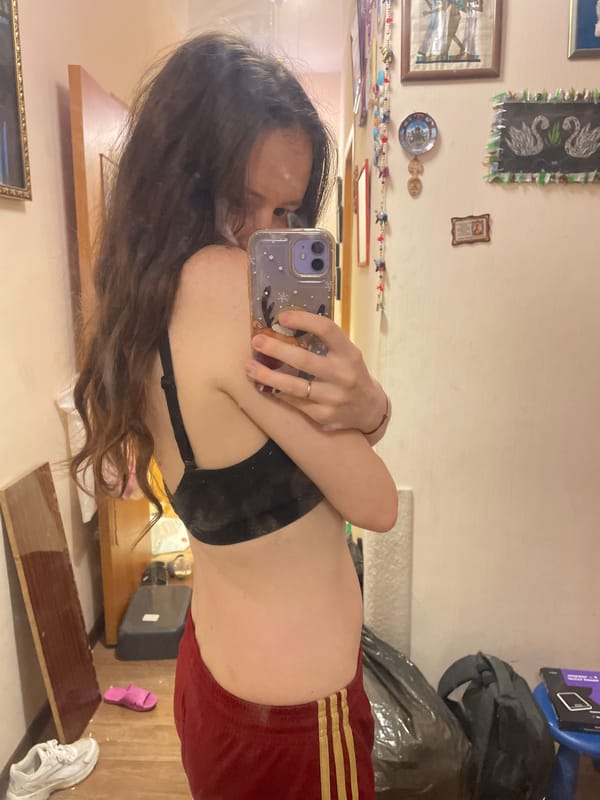 Woman takes selfies in cluttered room in Берёзовка