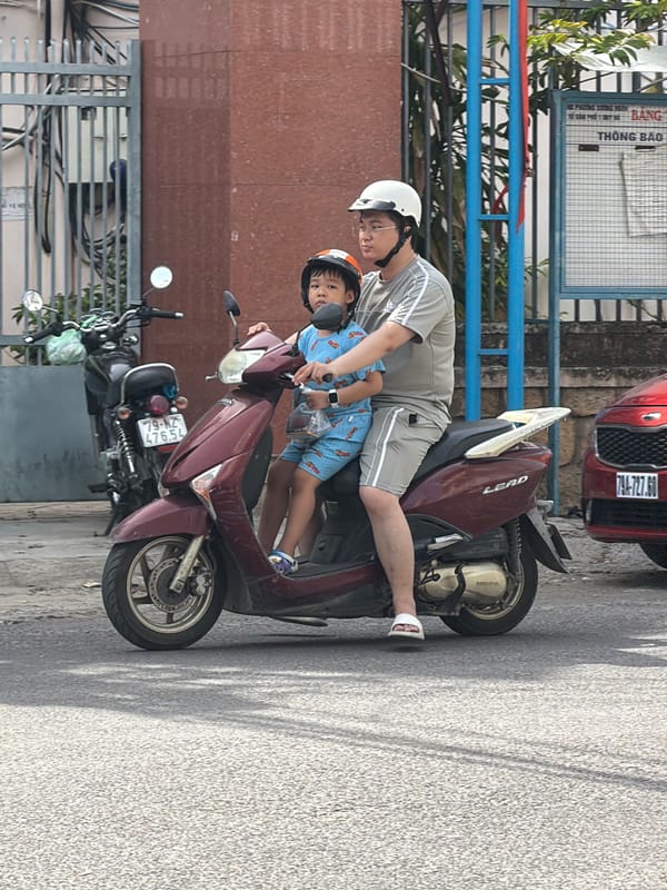 Everyday street traffic in Nha Trang, scooters and vans