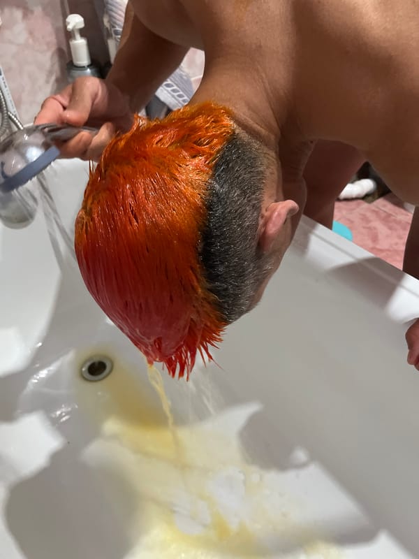 Person documents orange hair dye transformation in Chaikovsky, Russia