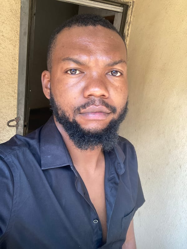 Man in black shirt observed indoors in Jos, Nigeria