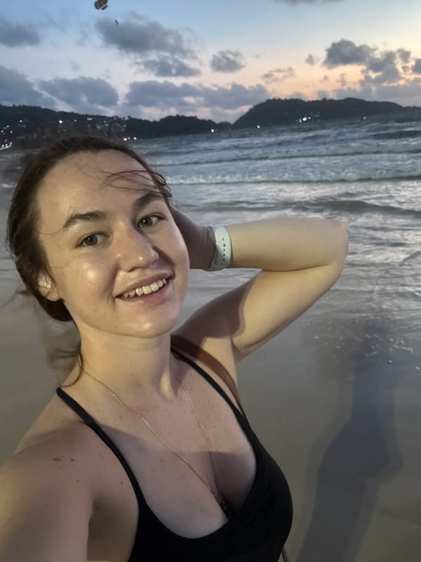 Dusk at Patong Beach: selfies, a Thai flag, and a jet ski