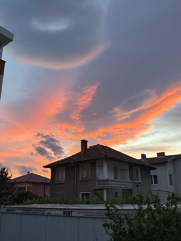 Orange-pink sunset illuminates residential Karlovo, Bulgaria skyline