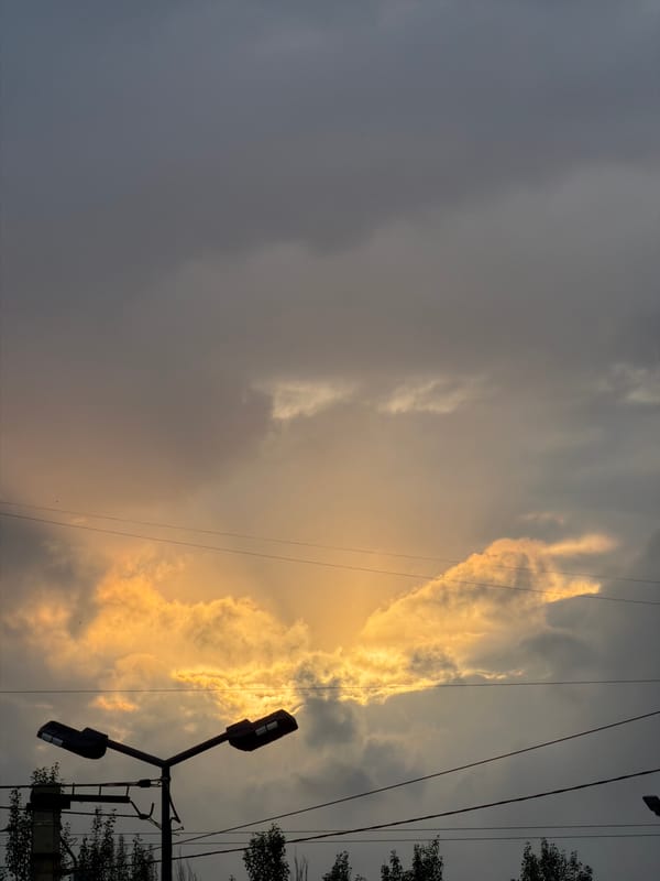 Dramatic golden light breaks through storm clouds over Bishkek
