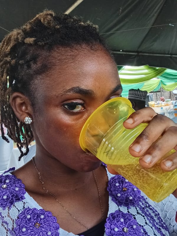 Woman dines on rice and meat in Shagamu, Nigeria