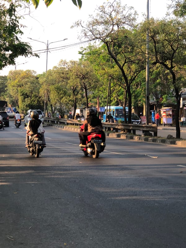 Morning traffic moves through a busy East Java road corridor