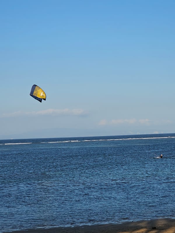 Kitesurfing off the Denpasar coast on a clear morning