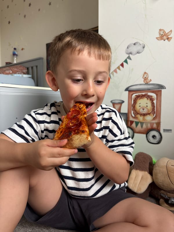 Boy enjoys pizza meal in London home