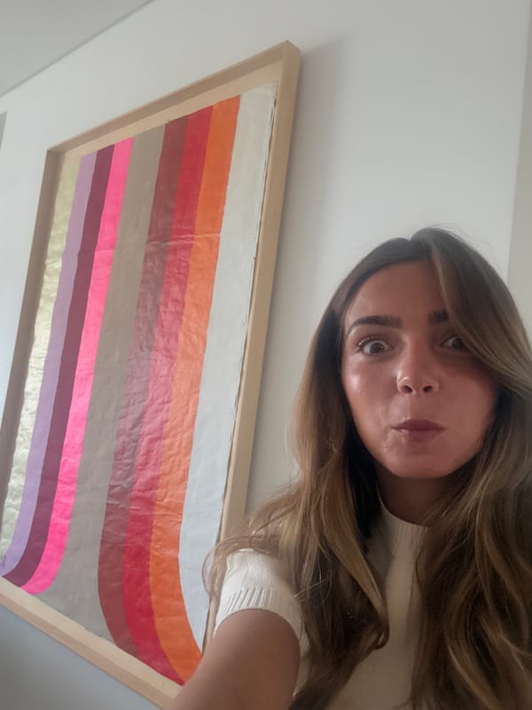 Woman takes selfie near striped artwork in Vila Nova de Gaia