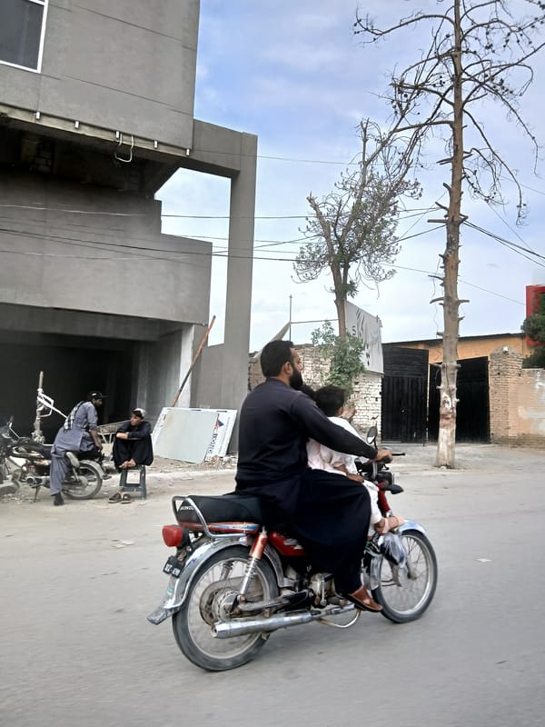 Street scene shows motorcycles with passengers in Quetta
