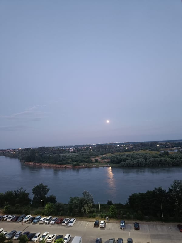 Kuban River and Krasnodar skyline at dusk, full moon rising