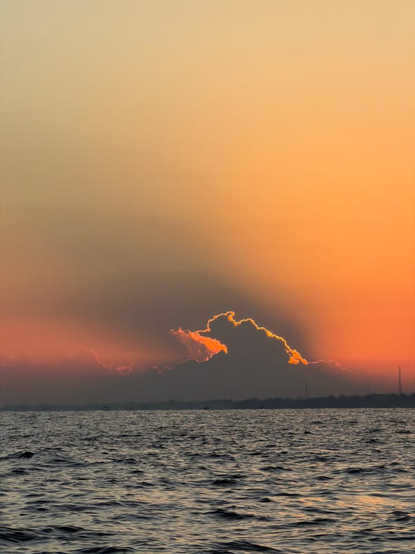 Traditional outrigger boats at sunset off Bali's north coast