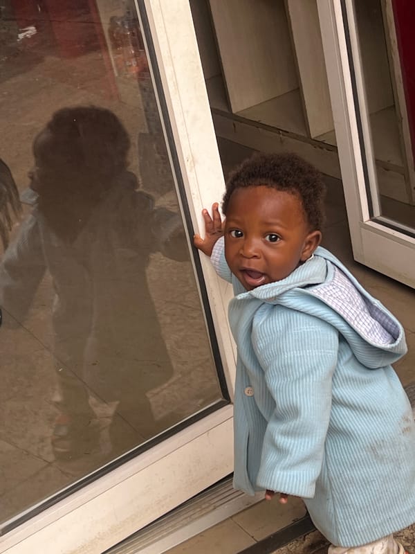 Child plays on tiled surfaces in Gura Top, Nigeria