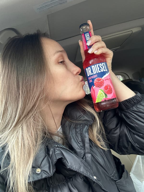 Woman enjoys flavored soda in vehicle in Myskhako