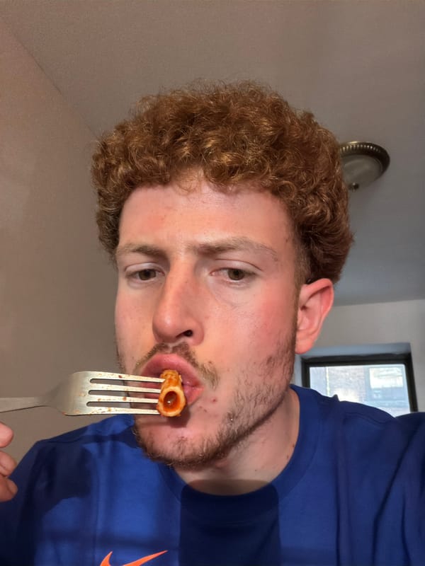 Man eats pasta in NYC apartment with basketball poster