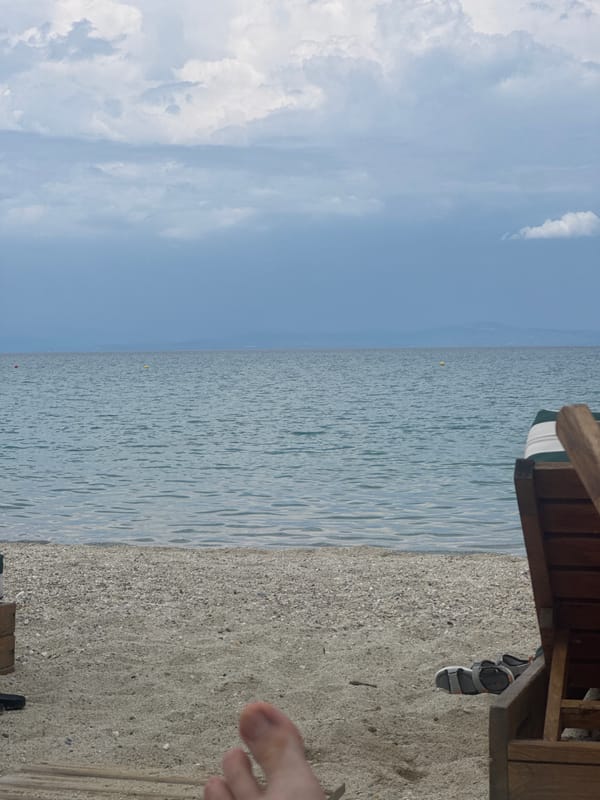 Summer beach day unfolds in Pallini, Greece with families and relaxation