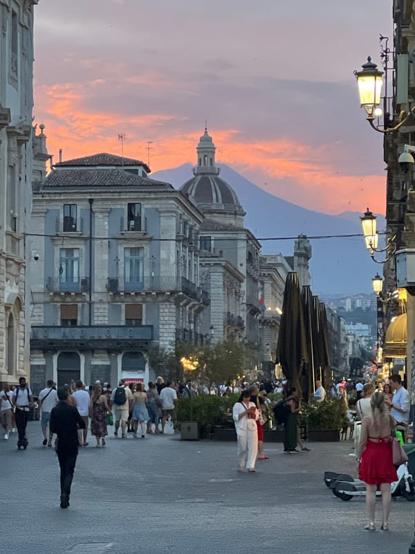 Catania's Baroque city center at dusk, Etna on the horizon
