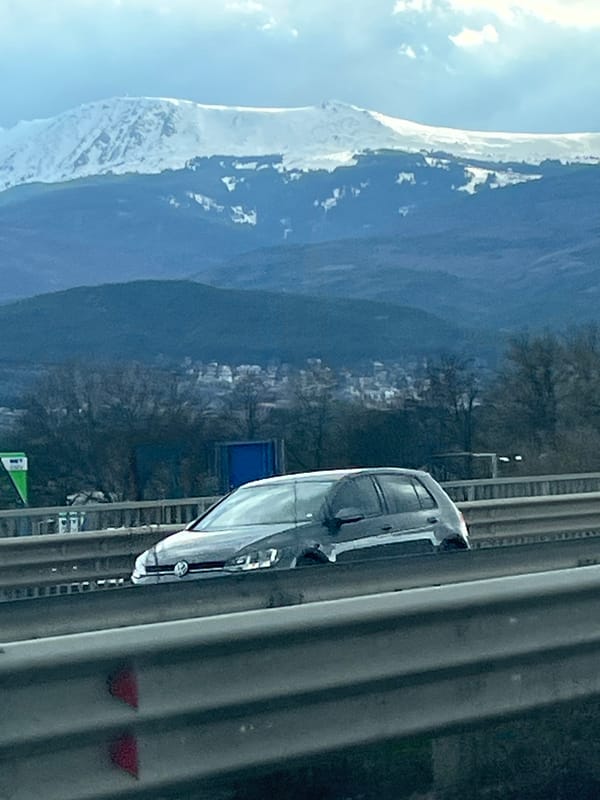 Highway journey past mountains and roadside signage documented