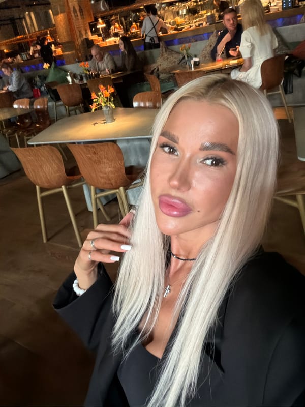 Woman takes selfies at restaurant during late morning
