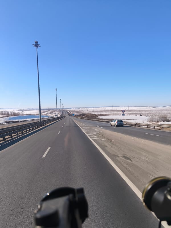 Highway bridge crosses snowy landscape in Shali, Russia