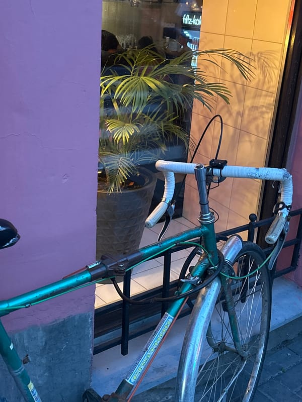 Inside a quirky cafe-bar with a vintage bicycle out front