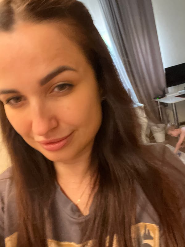 Woman takes multiple selfies during indoor photo session