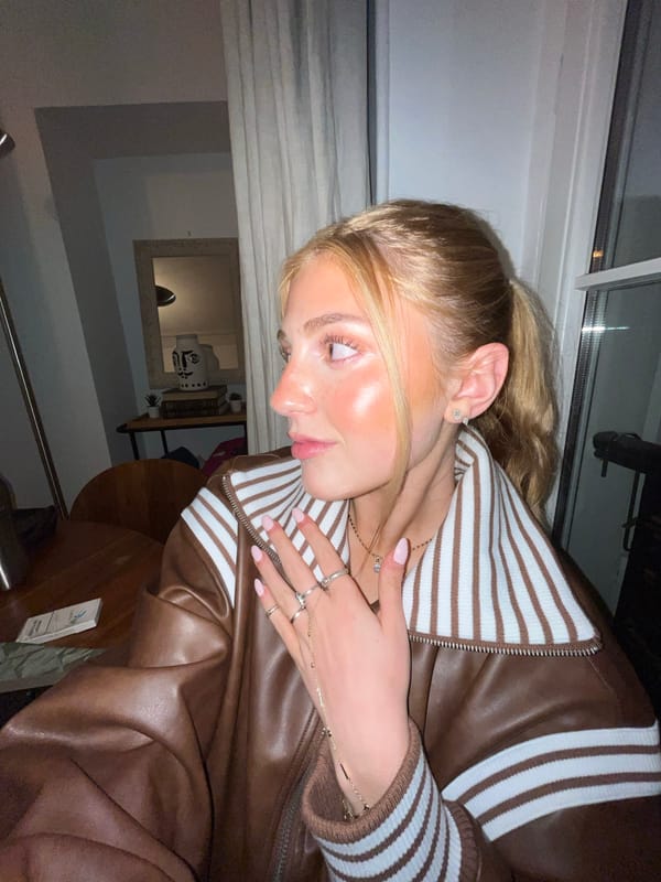 Blonde woman in leather jacket photographed indoors in Paris