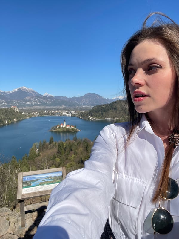 Tourist photographed at Lake Bled's scenic wooden dock