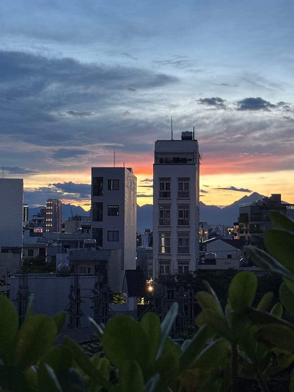 Da Nang skyline at dusk, rooftop views through shifting skies