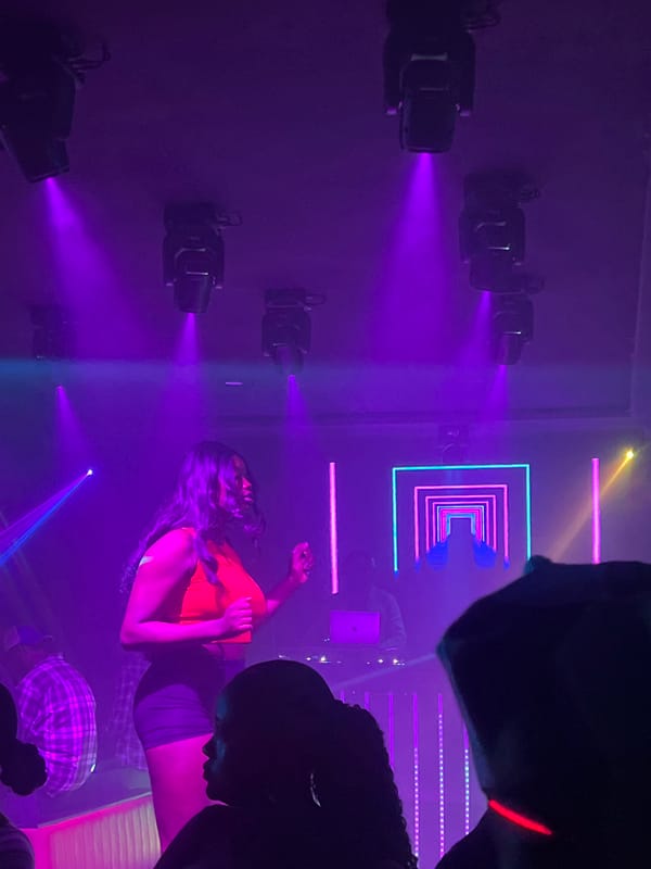 Nightclub scene captured in purple-lit venue in Howayi, Nigeria