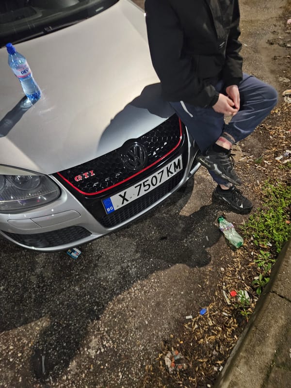 Person sits on car hood in Dimitrovgrad Bulgaria