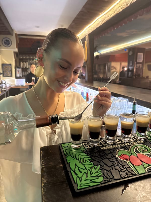 Bartender prepares shots at bar in Chaikovsky, Russia