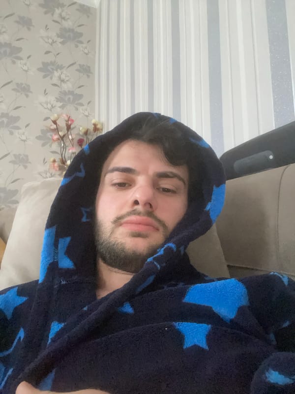 Man in star-patterned robe relaxes on couch in Tbilisi