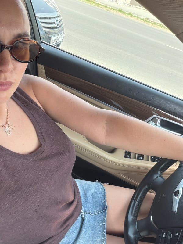 Woman photographed in Genesis car amid street scenes in Chaikovsky