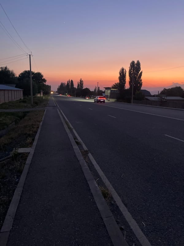 Dusk settles over a road in Taran-Bazar, Kyrgyzstan