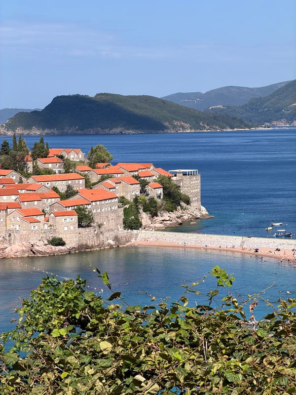 Sveti Stefan island and coastline on a busy summer morning