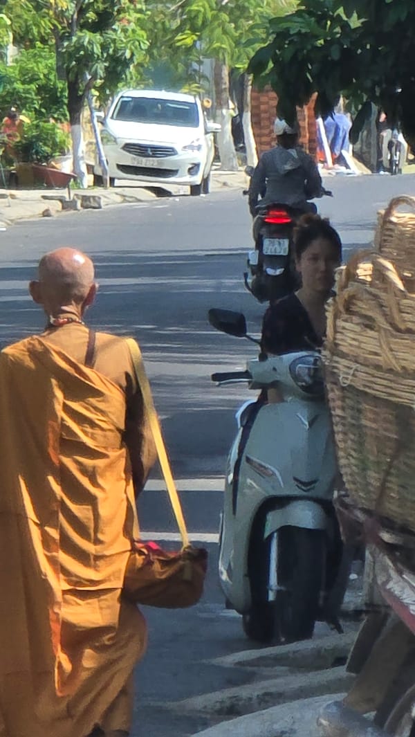 Buddhist monk walks barefoot through Nha Trang streets