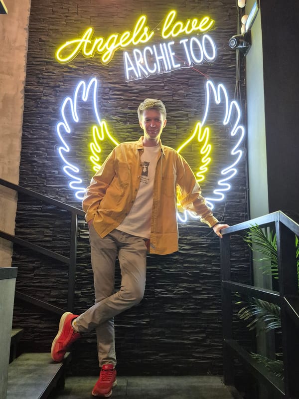 Social gathering at neon-lit venue in Izhevsk features angel-themed decor