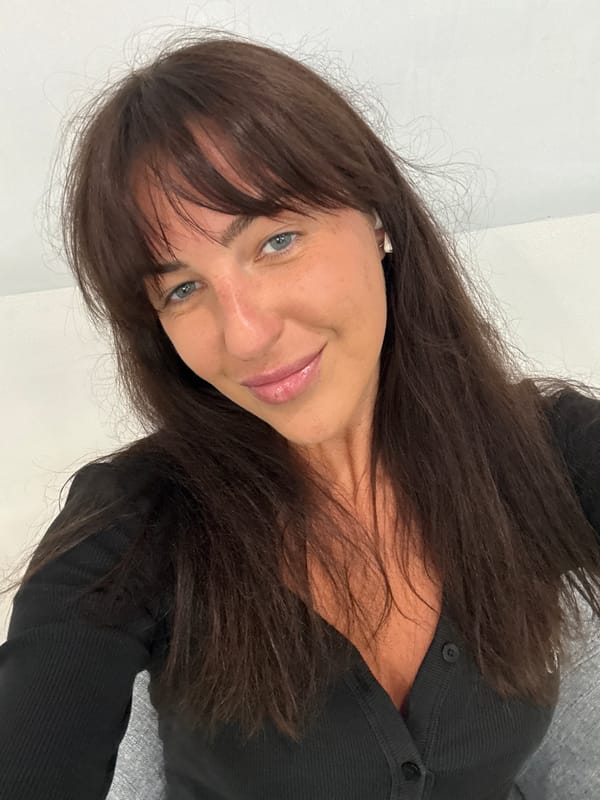 Woman in black top photographed indoors