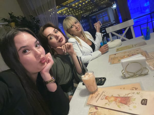 Three women photographed dining at urban restaurant