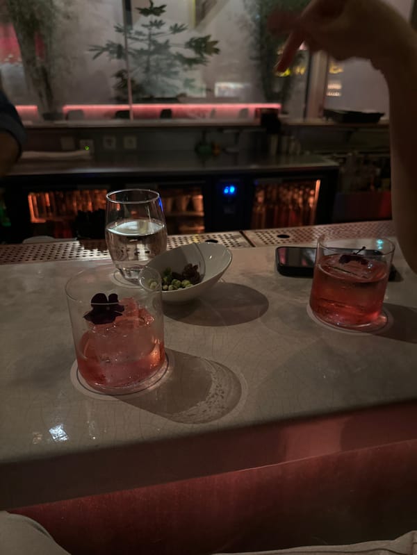 Two women enjoy evening drinks at restaurant location