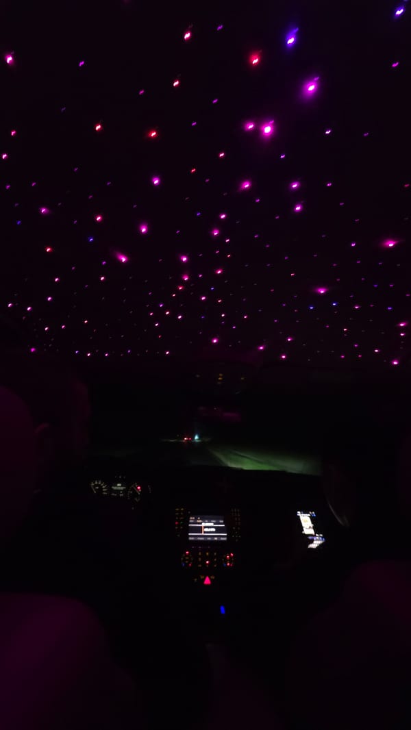 Dark vehicle interior with glowing decorations observed in Oreshak