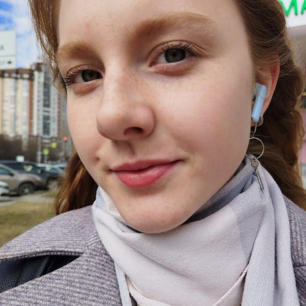 Woman photographed with white cat during morning hours