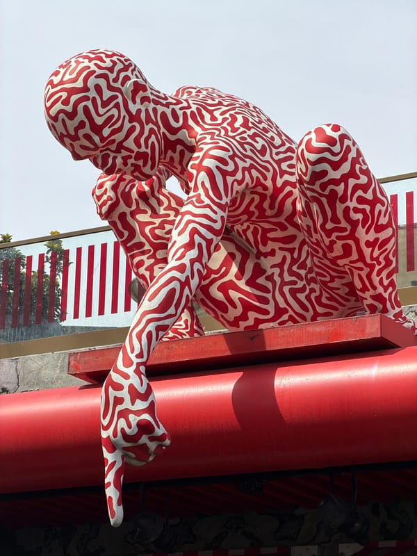 Maze-patterned human sculpture spotted near red column in Istanbul