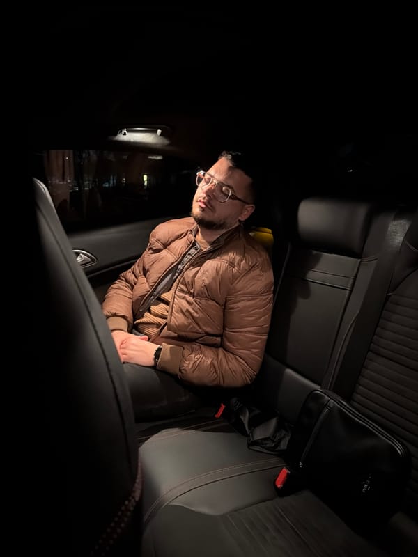 Man in glasses sits in car back seat in Bulgaria